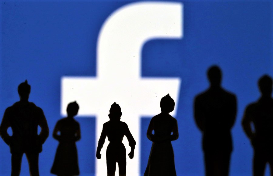 FILE PHOTO: Small toy figures are seen in front of Facebook logo in this illustration picture